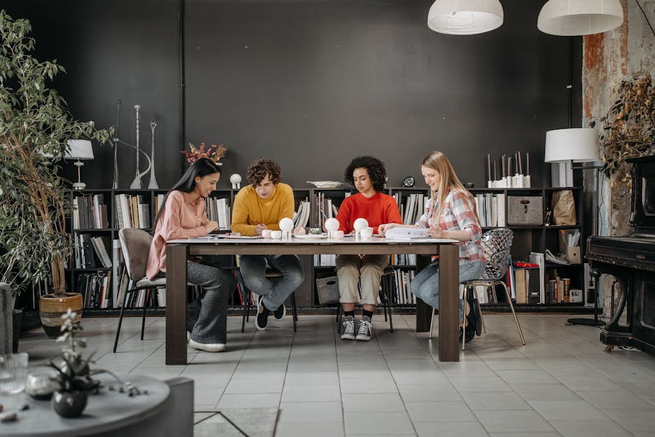 A diverse team of adults collaborating on a project in a modern office setting.